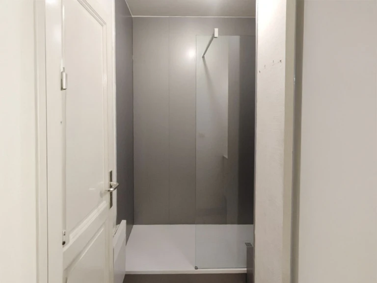 Salle de bain moderne avec douche à l'italienne, receveur blanc rectangulaire et parois vitrées